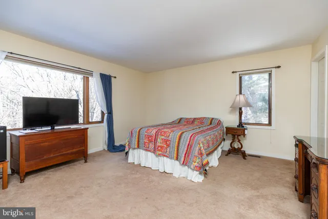 a bedroom with a bed and flat screen tv