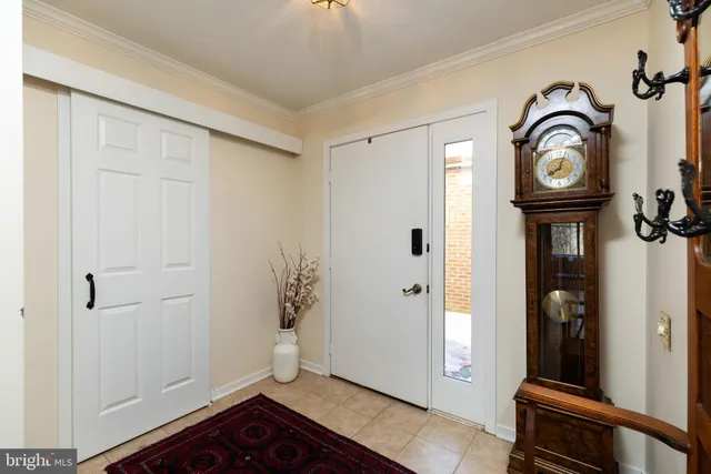 a view of a hallway with entryway wooden floor and front door
