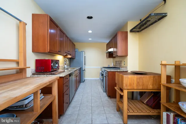 a kitchen with kitchen island granite countertop a sink counter top space and cabinets