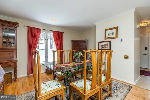 a dining room with furniture and wooden floor