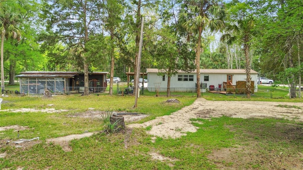 3650 176 Place Inglis, FL 34449 - Photo 36 of 49 a view of a house with swimming pool and a yard