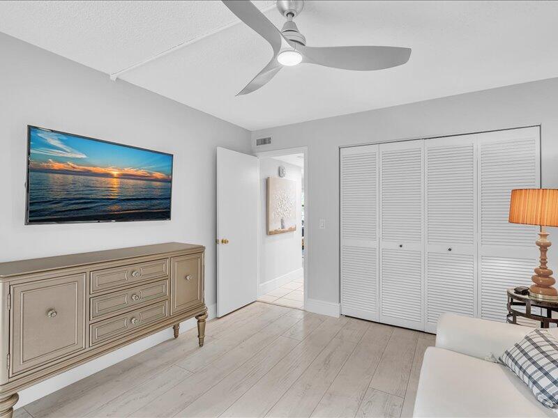 277 North Ocean Boulevard, Unit 102 Boca Raton, FL 33432 - Photo 31 of 53 a living room with furniture and a flat screen tv