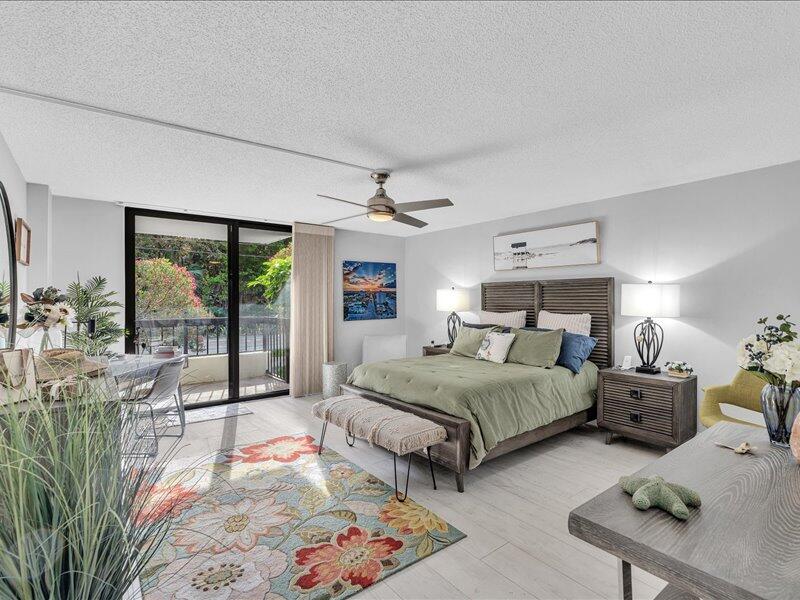 277 North Ocean Boulevard, Unit 102 Boca Raton, FL 33432 - Photo 33 of 53 a bedroom with bed and glass door