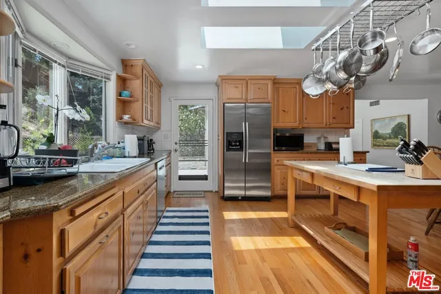 a kitchen with stainless steel appliances a sink and a refrigerator