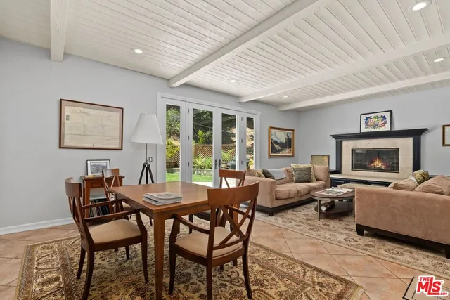 a dining room with furniture a fireplace and wooden floor