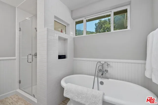 a bathroom with a bathtub and shower