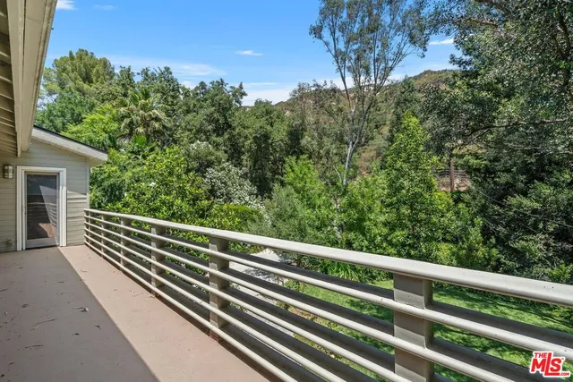 a view of mountain view with trees in the background