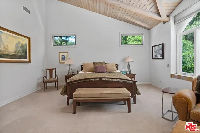 a bedroom with a bed chair and window