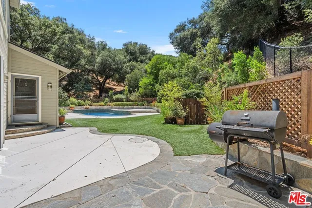 a view of a backyard with sitting area