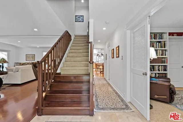 a view of entryway and hall with wooden floor