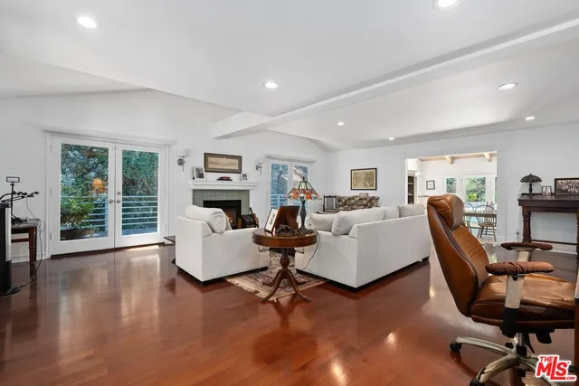 a living room with fireplace furniture and a wooden floor