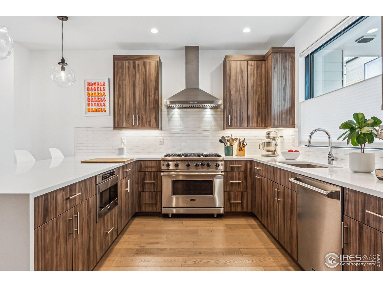 2471 Walnut Street Boulder, CO 80302 - Photo 15 of 36 a kitchen with stainless steel appliances a stove a sink dishwasher and cabinets with wooden floor