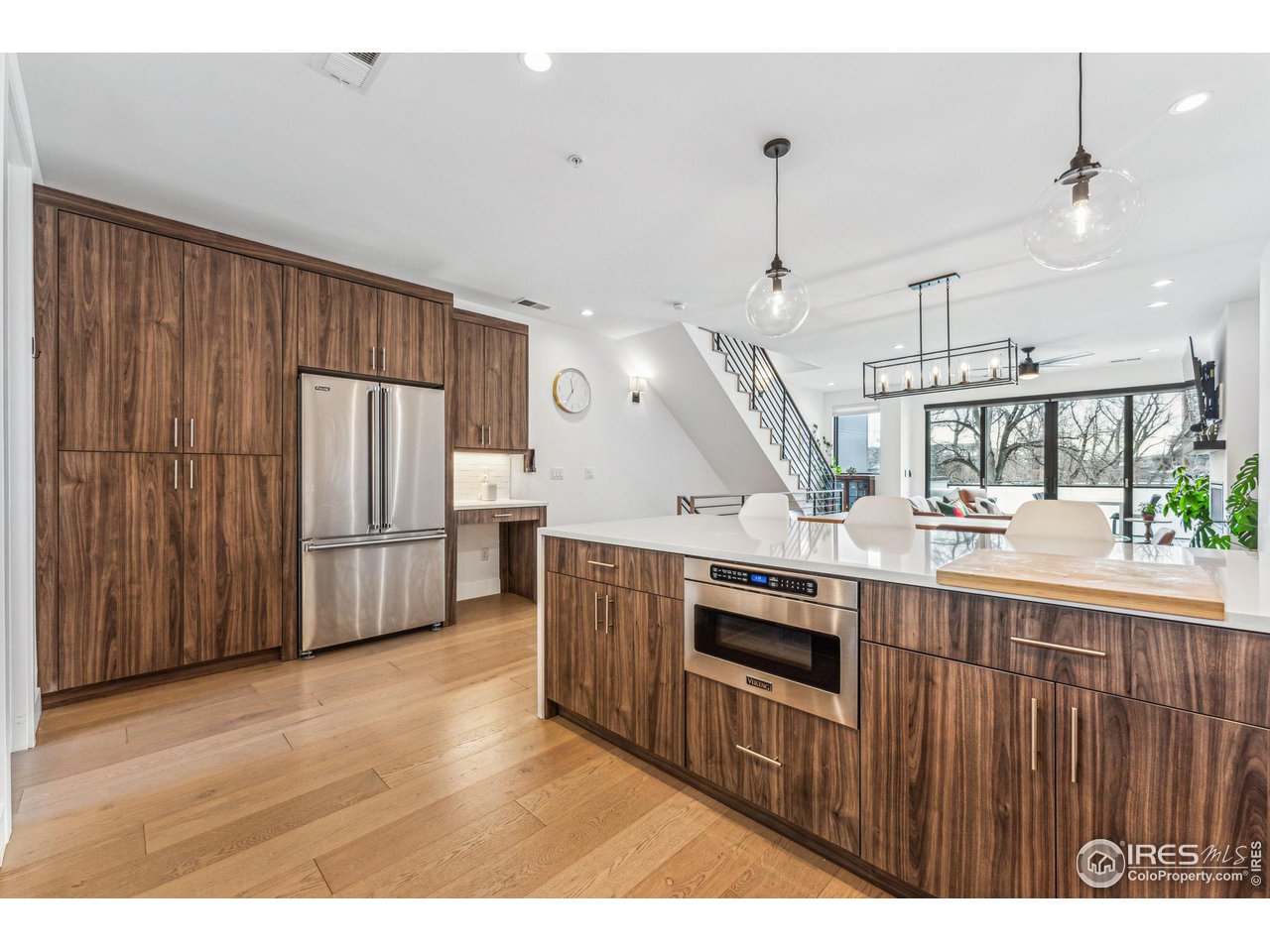 2471 Walnut Street Boulder, CO 80302 - Photo 18 of 36 a kitchen with stainless steel appliances kitchen island wooden floors and wooden cabinets