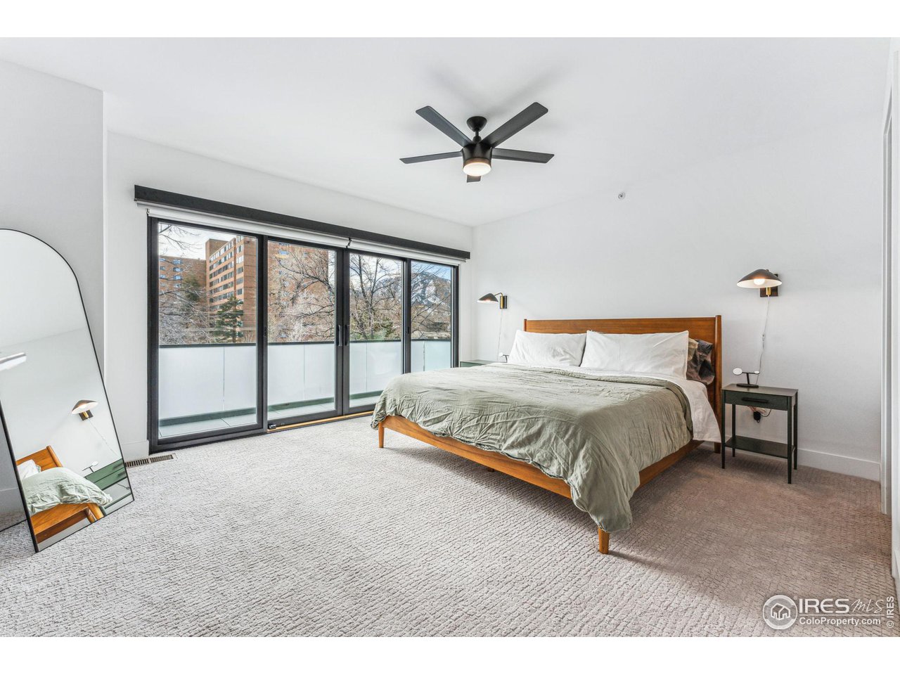 2471 Walnut Street Boulder, CO 80302 - Photo 21 of 36 a bedroom with a large bed and a chandelier