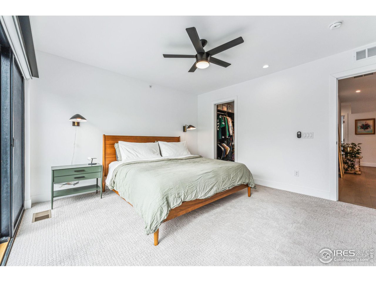 2471 Walnut Street Boulder, CO 80302 - Photo 22 of 36 a bedroom with a bed and a chandelier