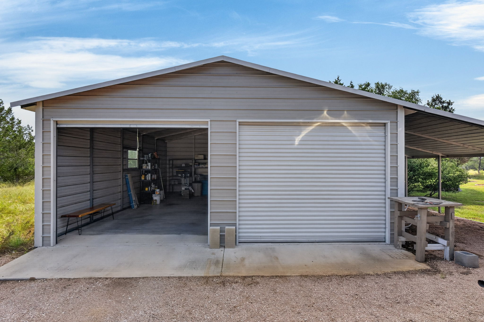 207 Deer Ridge Drive Burnet, TX 78611 - Photo 11 of 36 Functional metal building with two garage bays provides ample storage and workspace.