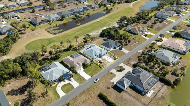 an aerial view of a house with a lake view