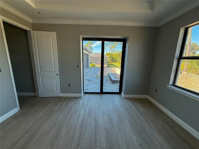 an empty room with wooden floor and sliding door
