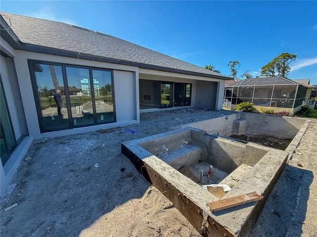 a view of a house with pool porch and furniture