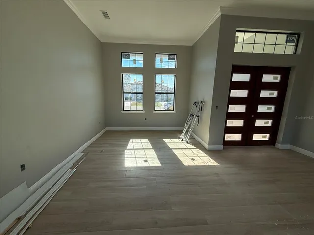 wooden floor in an empty room with a window