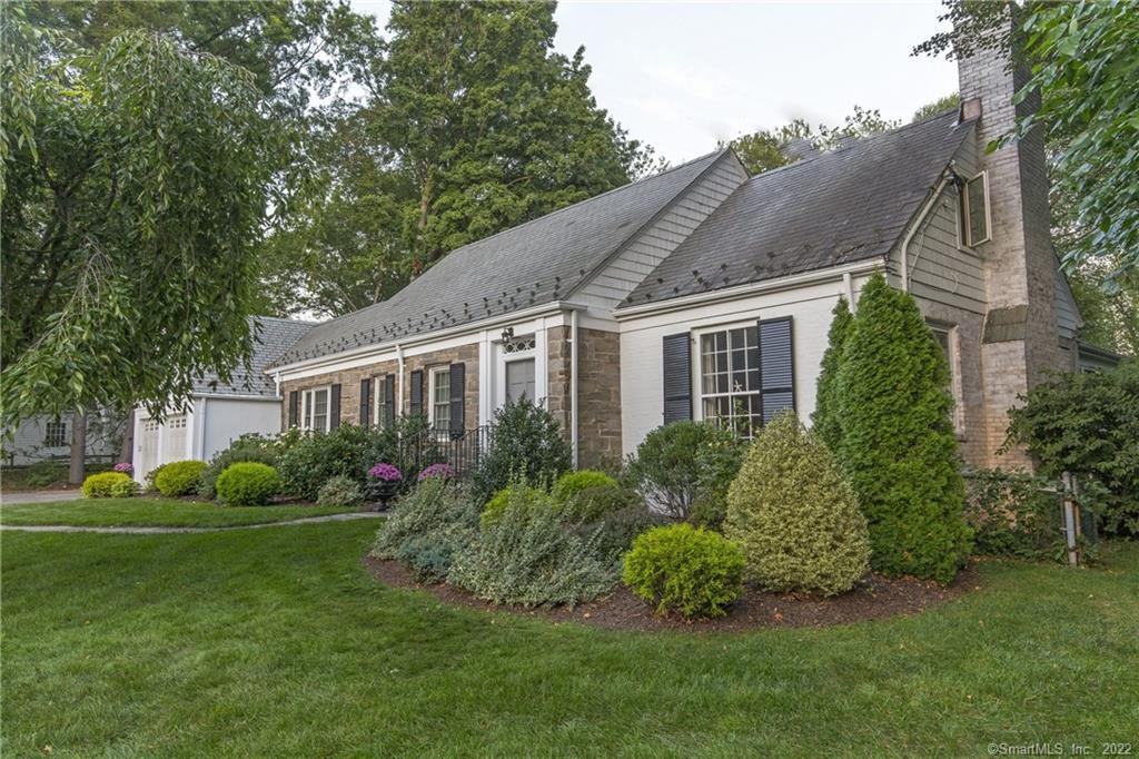 a front view of house with yard and green space