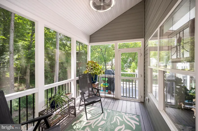 a bedroom with a bed a chandelier and a window