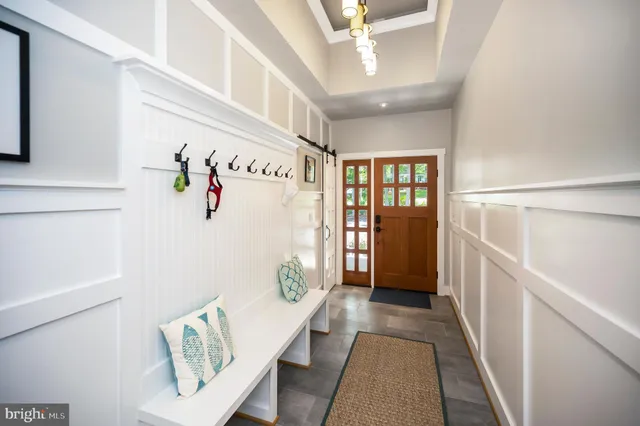 a hallway with wooden floor and windows