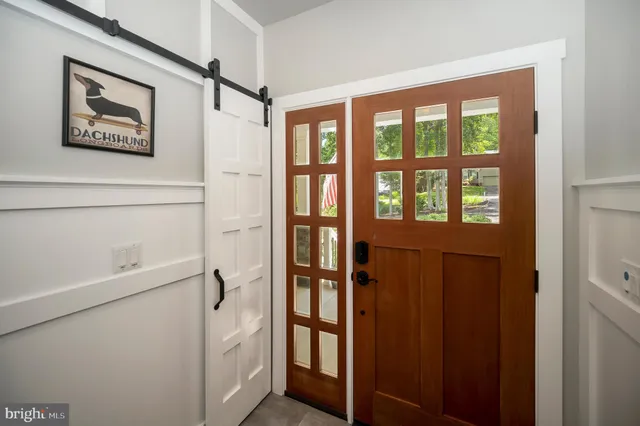 a living room with furniture a fireplace and a large window