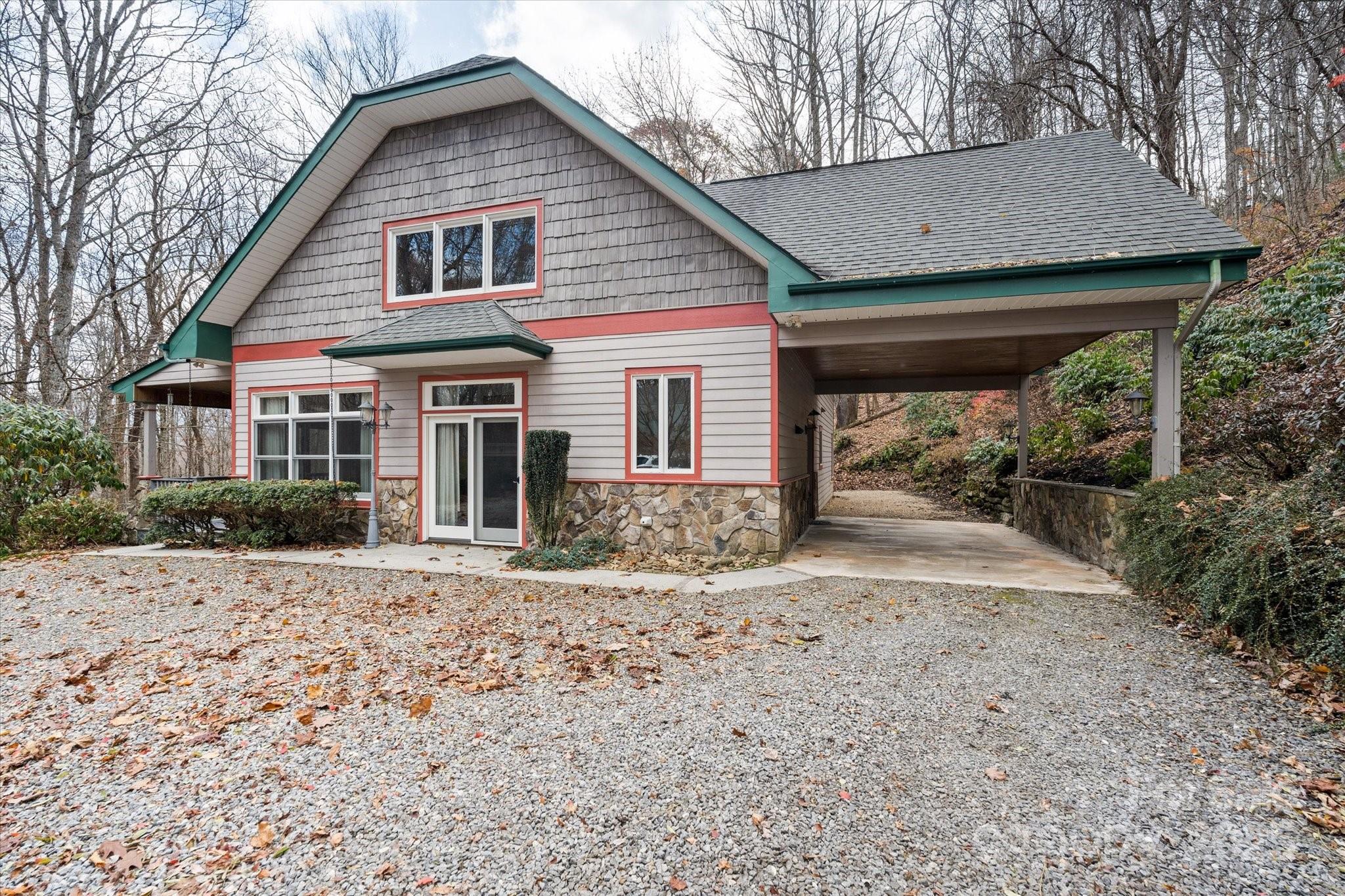 905 Old Fiddle Road Waynesville, NC 28786 - Photo 1 of 39 a front view of a house with a yard and garage
