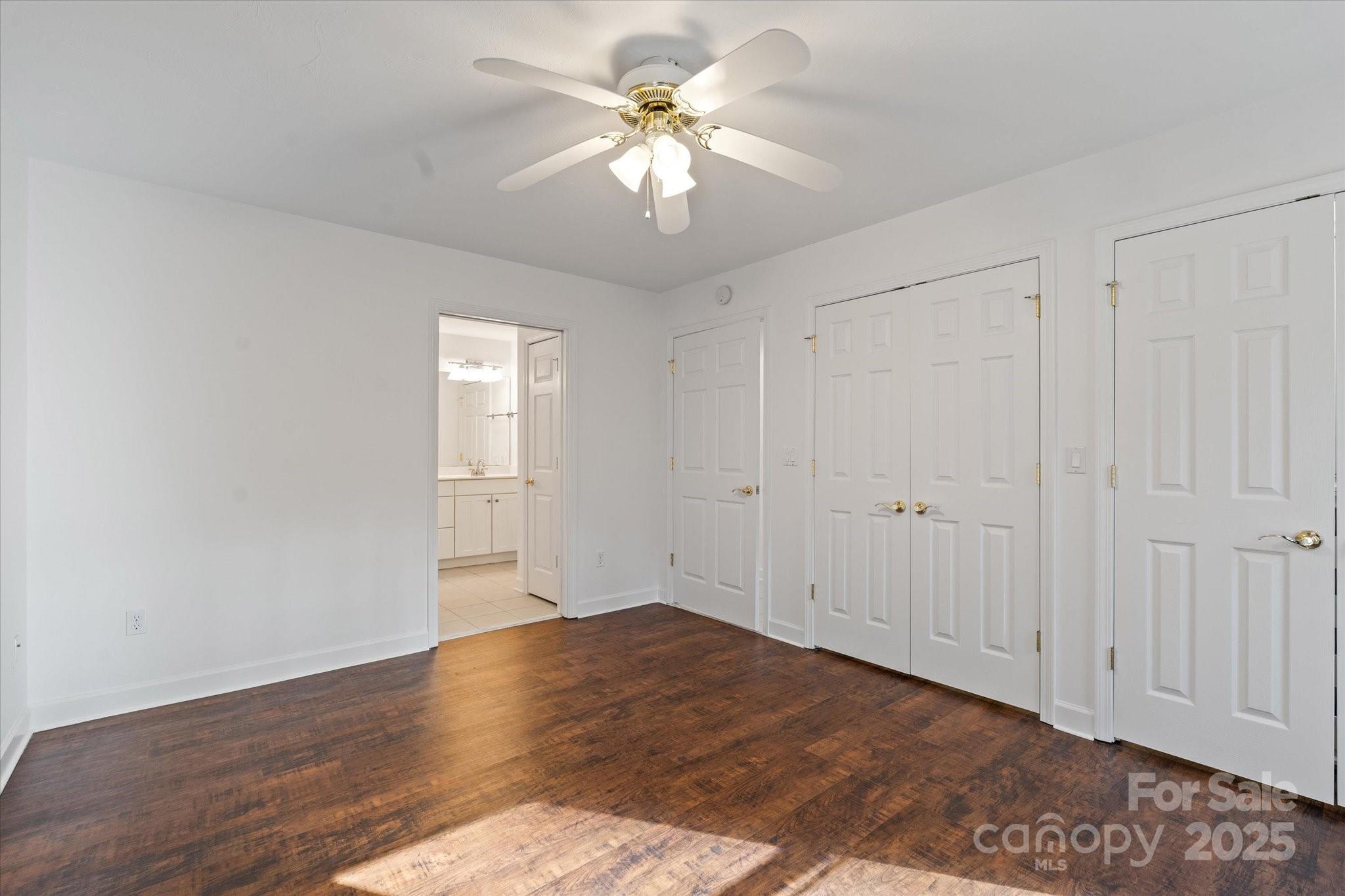 905 Old Fiddle Road Waynesville, NC 28786 - Photo 12 of 39 a view of an empty room with chandelier fan and wooden floor