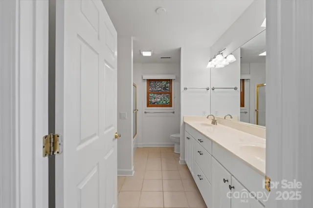 a bathroom with a double vanity sink mirror and double