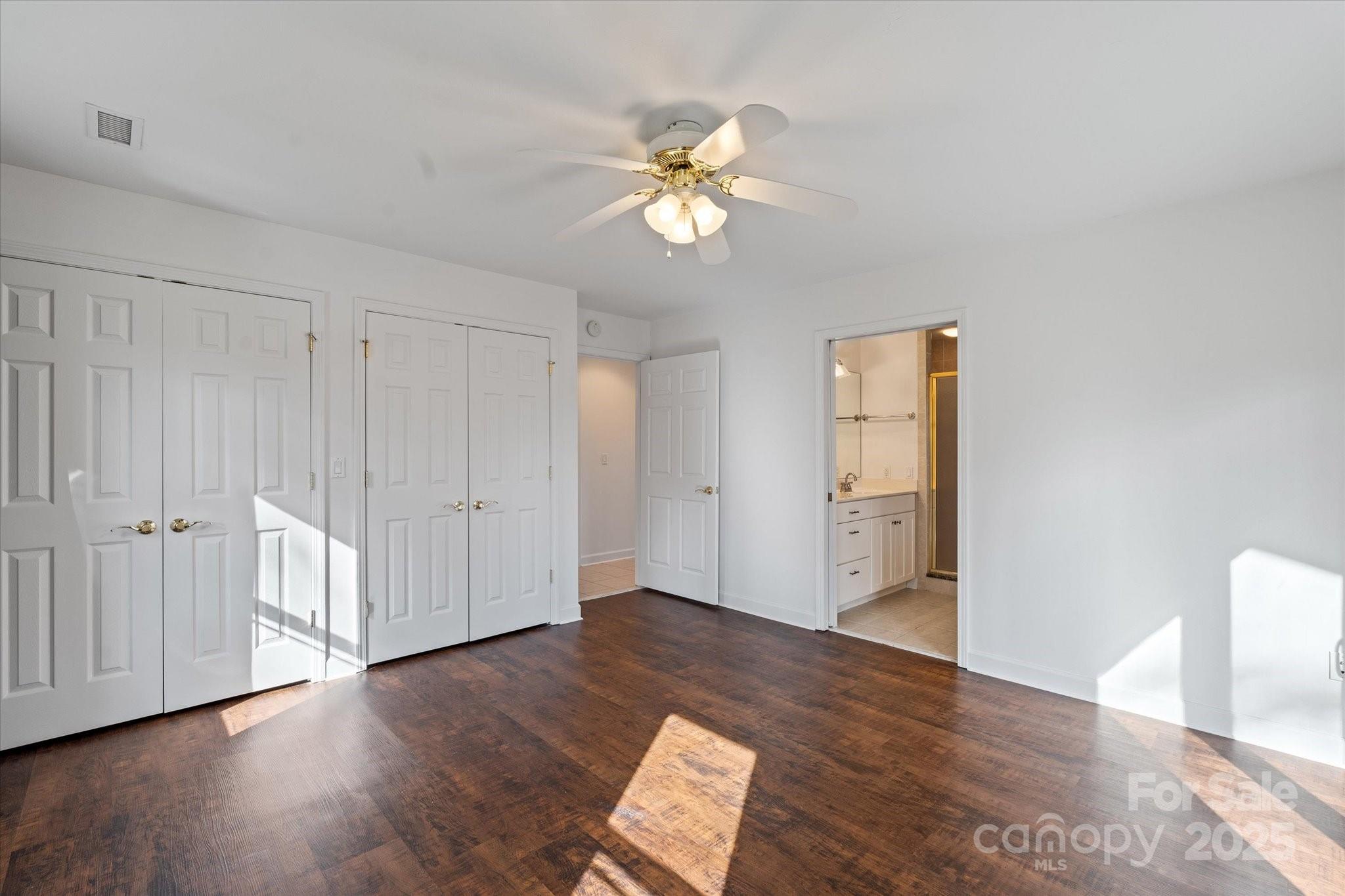 905 Old Fiddle Road Waynesville, NC 28786 - Photo 18 of 39 a view of an empty room with wooden floor and a ceiling fan