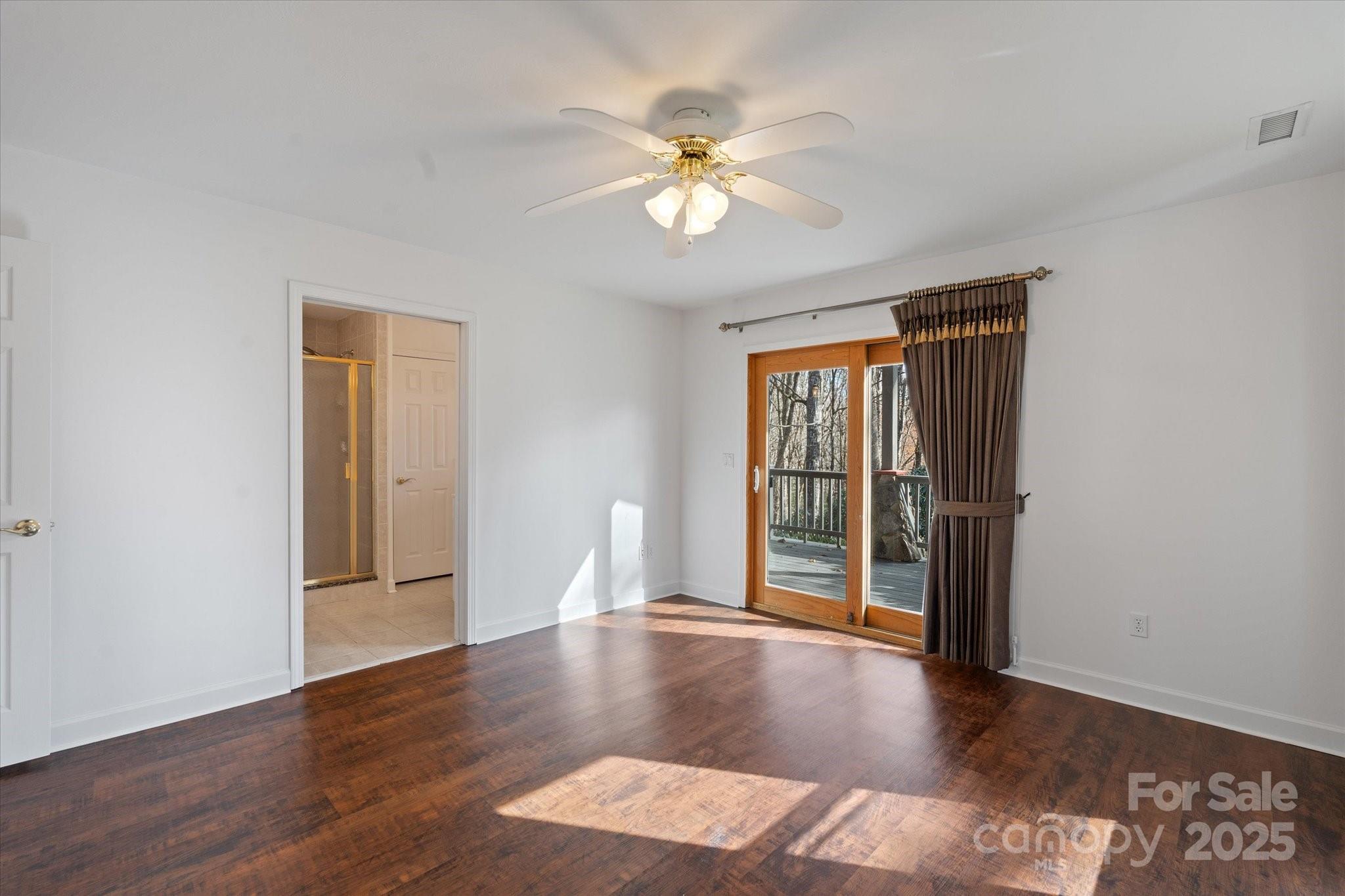 905 Old Fiddle Road Waynesville, NC 28786 - Photo 19 of 39 a view of an empty room with wooden floor and a window