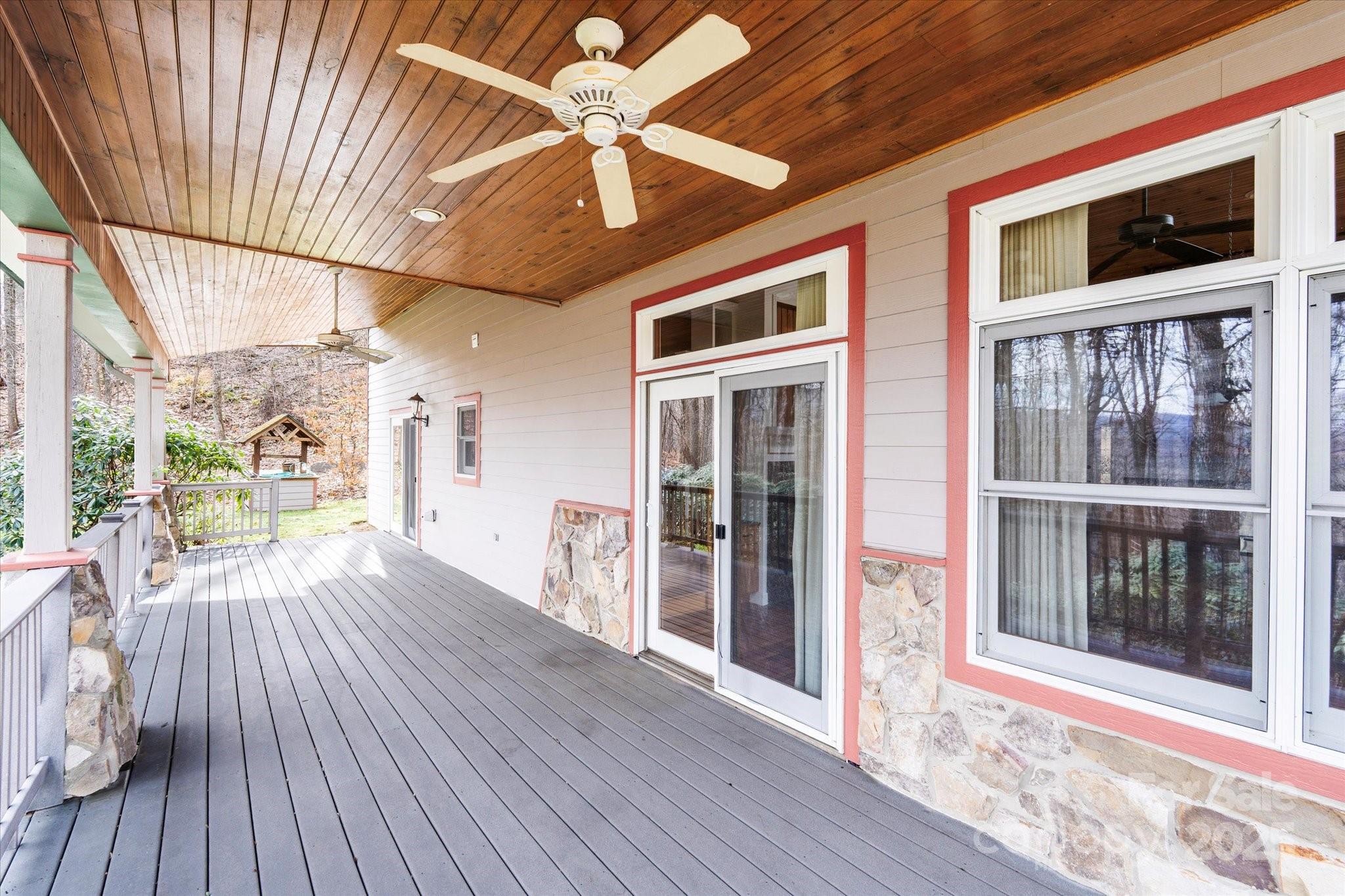 905 Old Fiddle Road Waynesville, NC 28786 - Photo 3 of 39 a view of a porch with wooden floor and chandelier