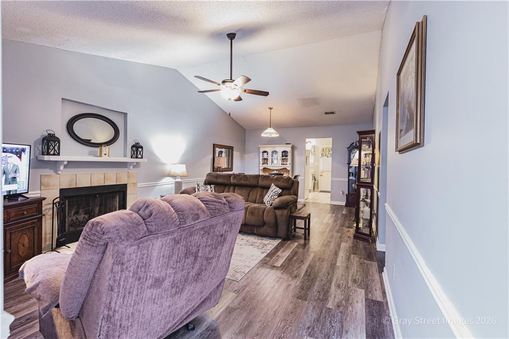 a living room with furniture a fireplace and a window