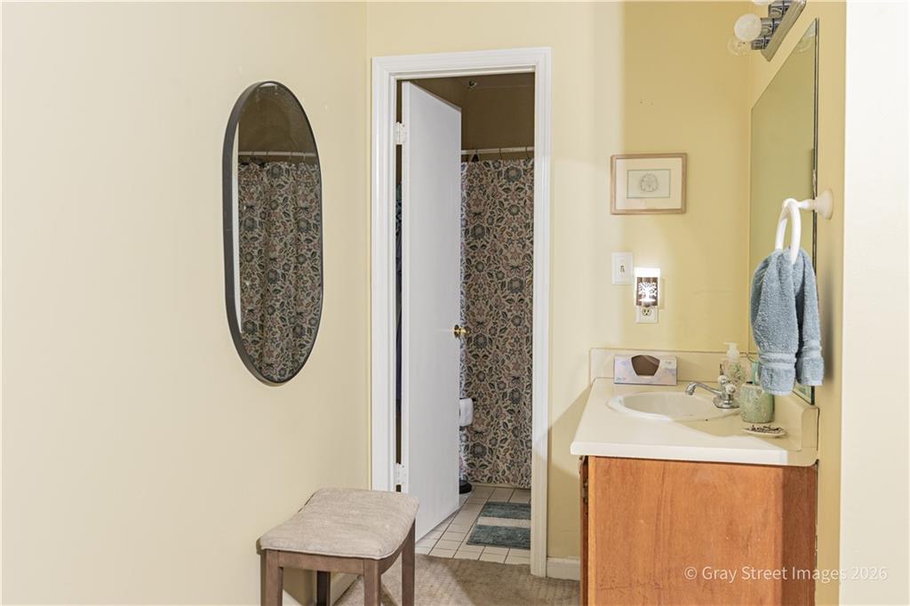 2019 Shields Road, Unit 8 Dalton, GA 30720 - Photo 14 of 17 a bathroom with a sink a mirror and a shower