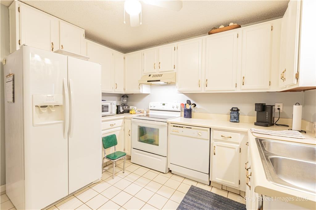 2019 Shields Road, Unit 8 Dalton, GA 30720 - Photo 16 of 17 a kitchen with white cabinets and white appliances