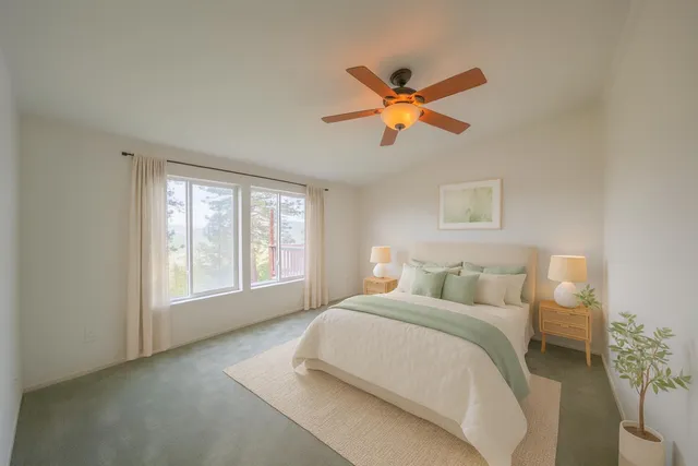 a view of a patio with couches potted plants and large tree