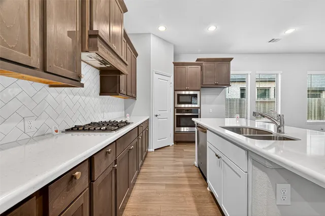 a view of a kitchen with wooden floor and a kitchen