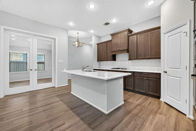 a bedroom with bed and a large window with potted plants