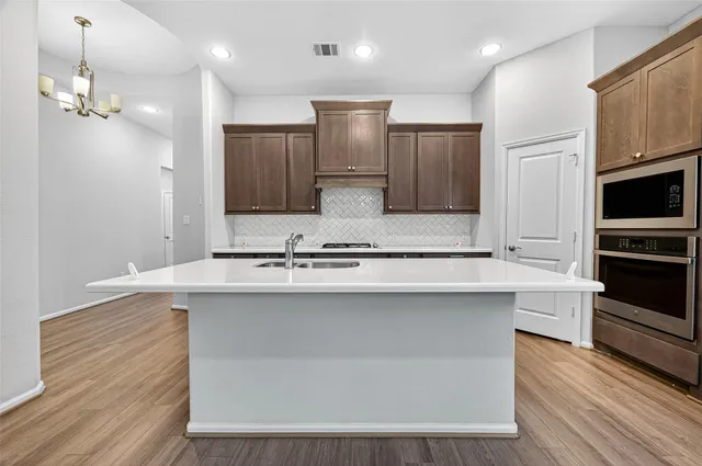 a bathroom with a tub sink and mirror