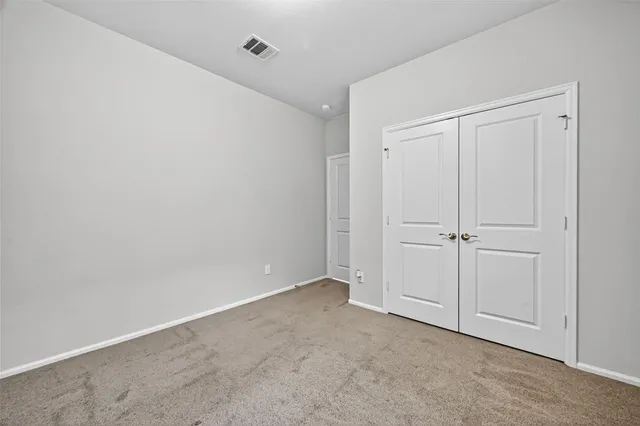 a view of a backyard with a garden and wooden fence