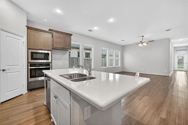 a kitchen with stainless steel appliances granite countertop a sink and stove
