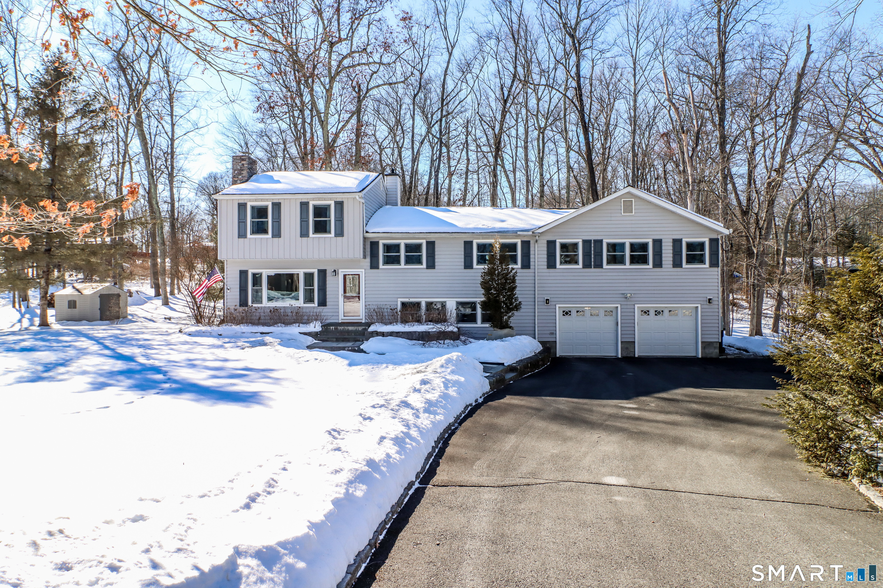 8 Marilyn Road Brookfield, CT 06804 - Photo 1 of 37 a front view of a house with a yard covered in snow
