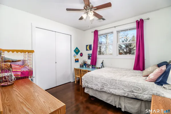 a bedroom with a bed and a table in it
