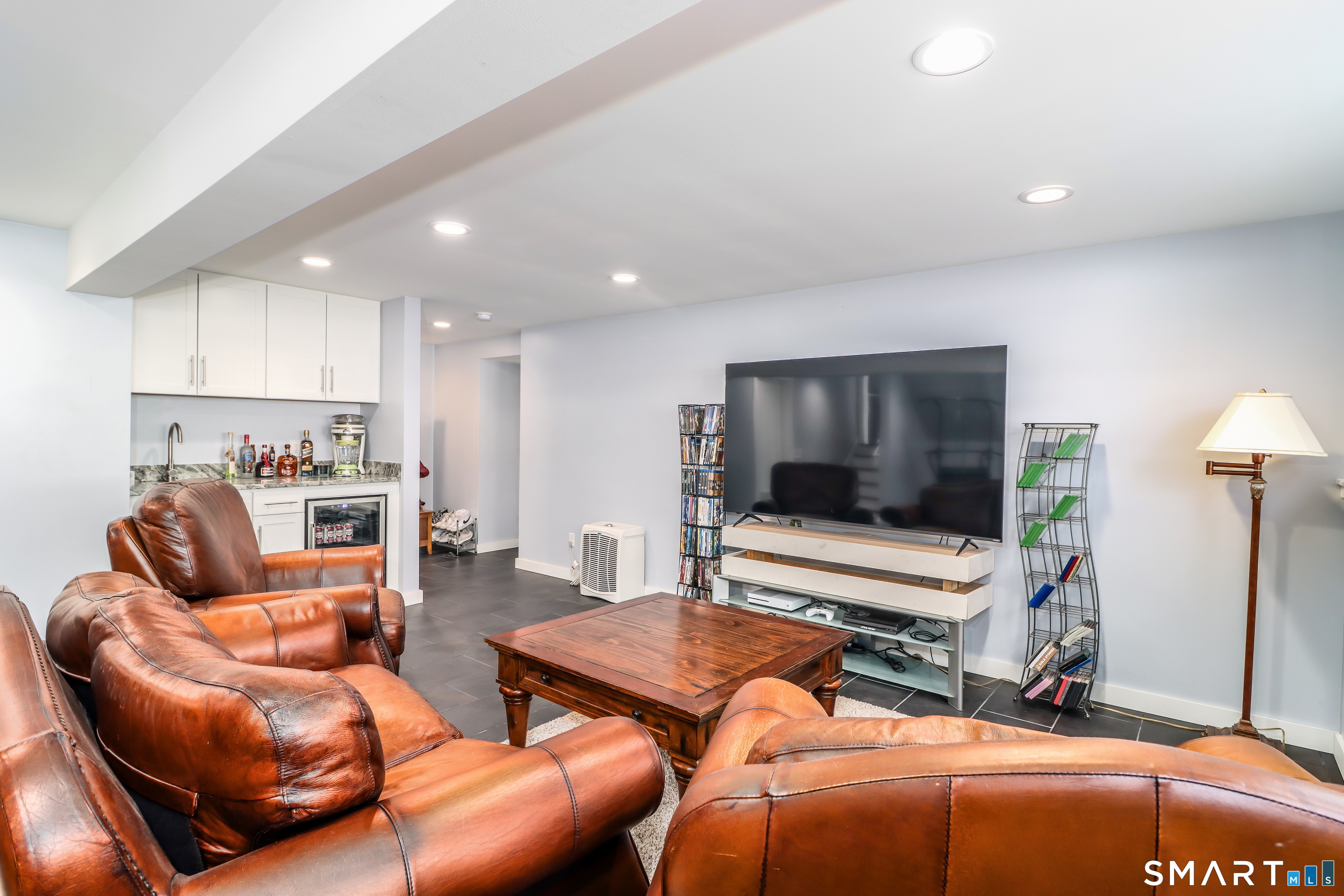 8 Marilyn Road Brookfield, CT 06804 - Photo 36 of 37 a living room with furniture and a flat screen tv
