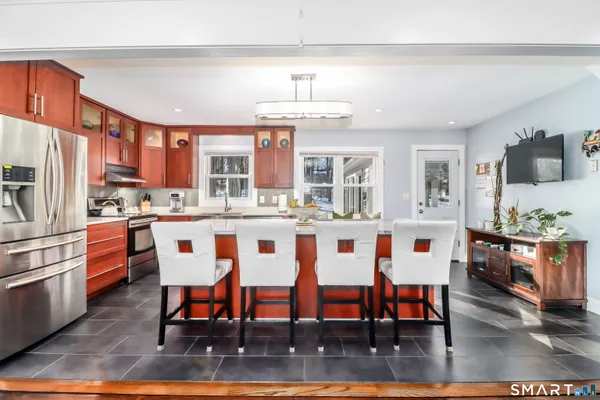 a large kitchen with a table and chairs