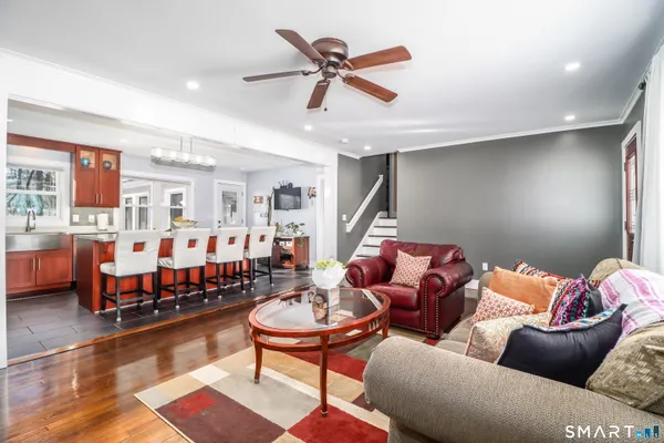 a living room with furniture a rug and a chandelier