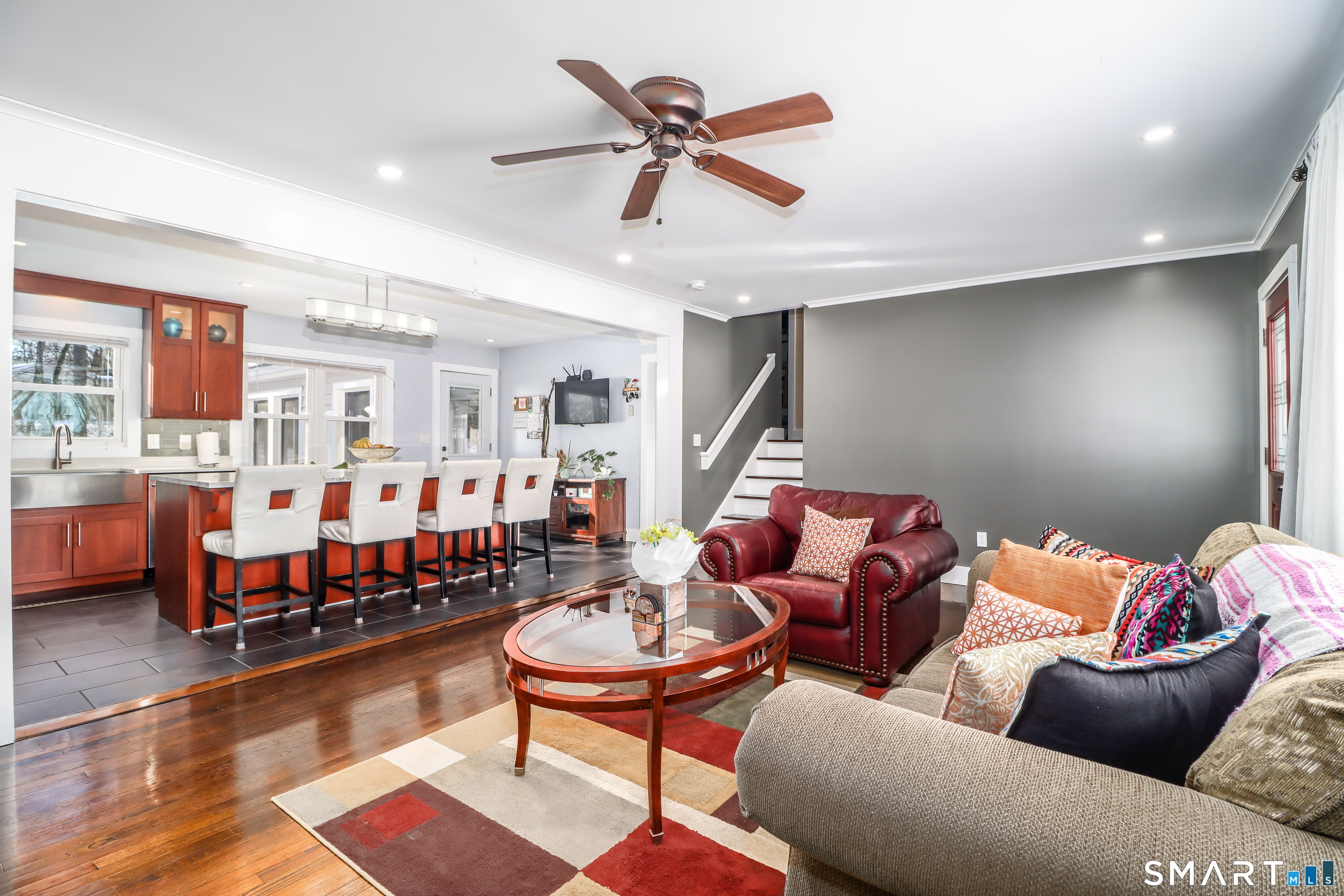 8 Marilyn Road Brookfield, CT 06804 - Photo 6 of 37 a living room with furniture a rug and a chandelier