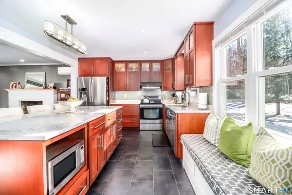 a kitchen with stainless steel appliances granite countertop a stove and a sink